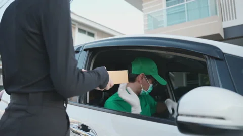 Asian delivery man send a package to customer on the cargo car. Stock Footage 213592732