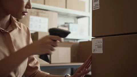 Asian Delivery Service Worker Using Scanner on Parcels in Boxes for Shipping 스톡 동영상 281716835