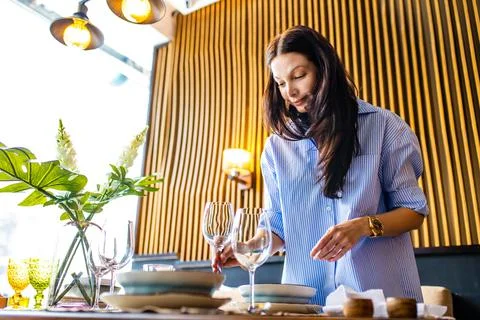 Asian designer etiquette teacher showing how correct set a dishes in a Stock Photos