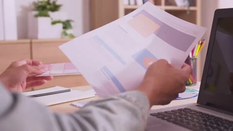 Asian designer hold a layout with different colors and select colors for desi Stock Footage 172426469