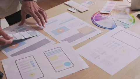 Asian designer hold a layout with different colors and select colors for desi Stock Footage 172429592