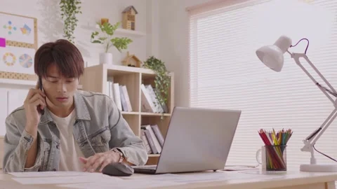 Asian designer man uses his smartphone to communicate. Work on projects and p Stock Footage 172425482