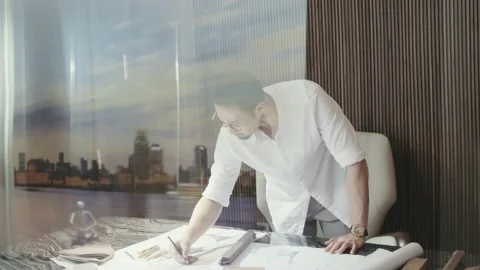 Asian designer standing behind table contemplating and sketching Stock Footage 160943745