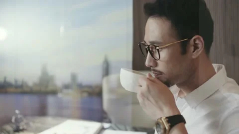 Asian designer taking a coffee break in office walking and looking out window Stock Footage 161055254