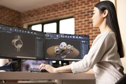 Asian developer analyzing 3D models on computer Foto stock