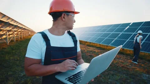 Asian developer engineer managing solar panel batteries by using portable laptop Stock Footage 138892078