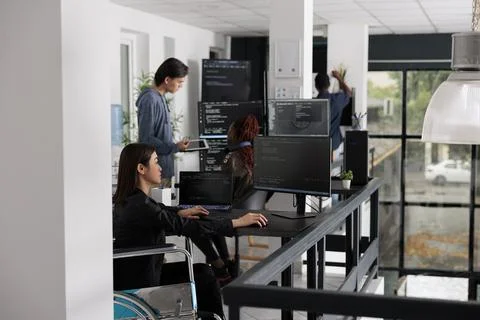 Asian disabled software programmer writing html code in agency big data room Stock Photos