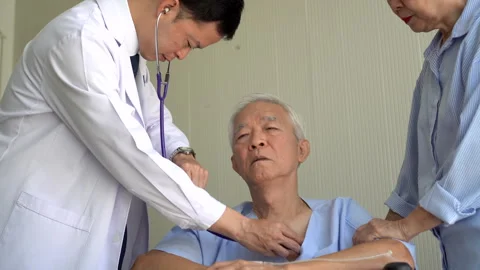 Asian doctor checking on pulse of  senior elderly man on wheelchair with wi.. Stock Footage 295665671