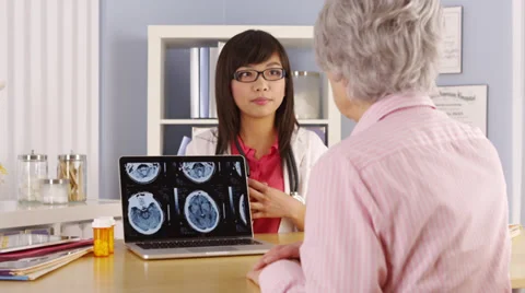 Asian doctor explaining brain scans to elderly patient Stock-Footage 39803455