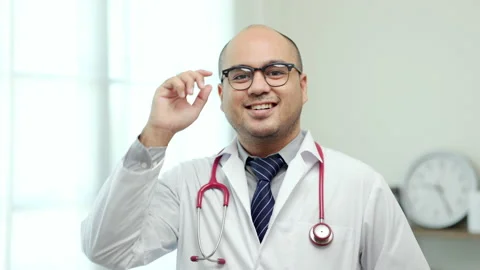 Asian doctor standing posing work from home. Positive male physician. Stock Footage 161208896