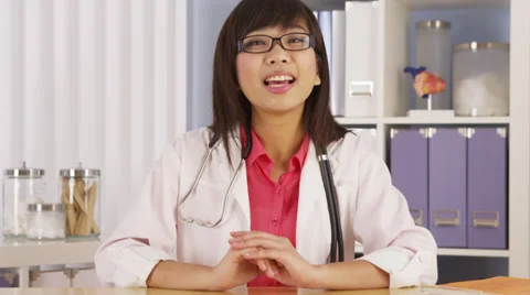 Asian doctor talking to camera Stock Footage