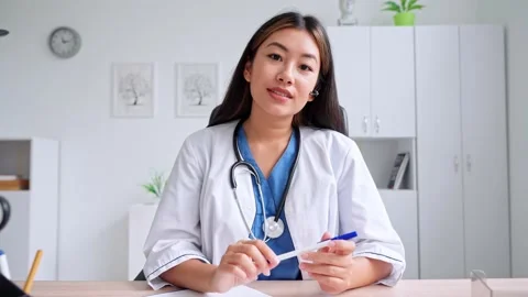 Asian doctor talking to web cam consulting via virtual telemedicine advice Video stock 218473637