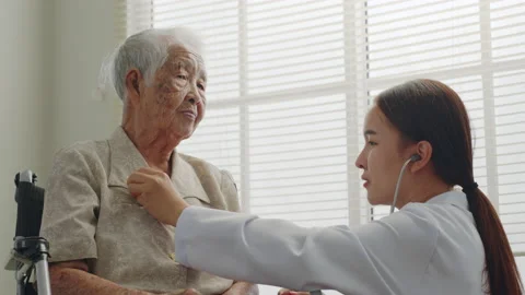 Asian doctor using stethoscope checking on senior old woman patient chest Stock Footage 196922721