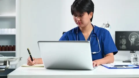 Asian doctor using tablet and laptop in office. Concept of healthcare, tele.. Stock Footage 312773509