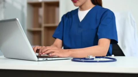 Asian doctor using tablet and laptop in medical office. Concept of healthca.. Stock Footage 312774204