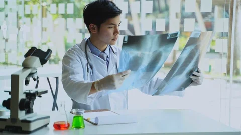 Asian Doctors working hard while Coronavirus Pandemic, looking at Pneumonia. Stock Footage 127244860