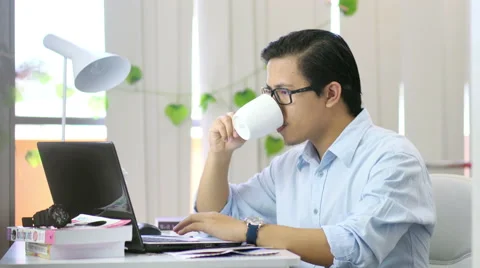 Asian Drinking Coffee at Work - 4K Resolution Stock-Footage 60606162
