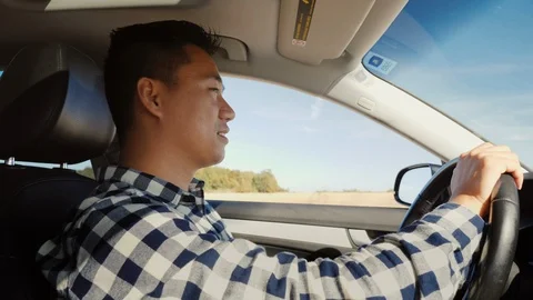 Asian driver driving a car Stock Footage 119489928