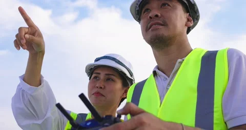 Asian Drone Operator Inspecting Construction Building With Drone Stock Footage 139434938