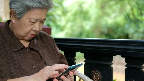 Asian elder senior woman using mobile smart phone. elderly holding cellphone Stock Footage 134946451