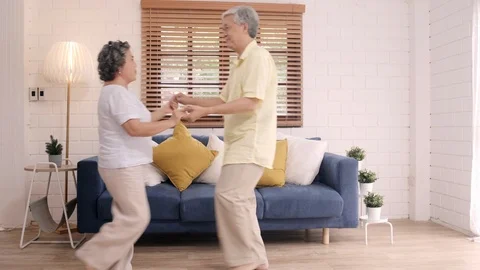 Asian elderly couple dancing together while listen to music at home. Stock Footage 102136343