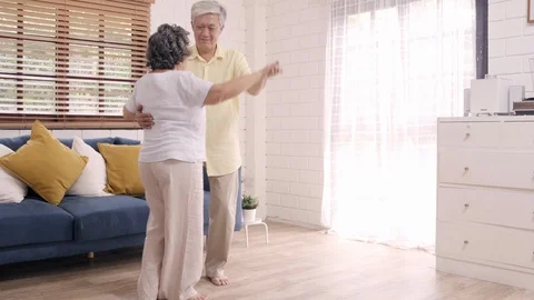 Asian elderly couple dancing together while listen to music at home. 스톡 동영상 102523852