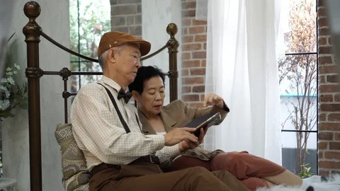 Asian elderly couple using smartphone in vintage home Video stock 97121196