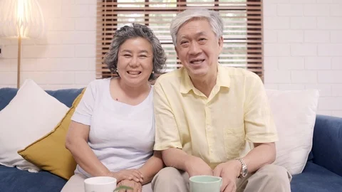 Asian elderly couple using smartphone video conference at home. Stock Footage 102136728