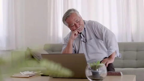 Asian Elderly man stressed sitting in the living room After meeting online. Video stock 153783940