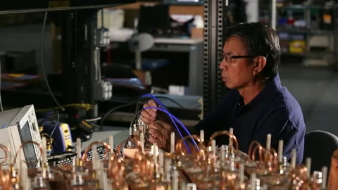 Asian electrical engineer with tools testing computer component Stock Footage 139071901