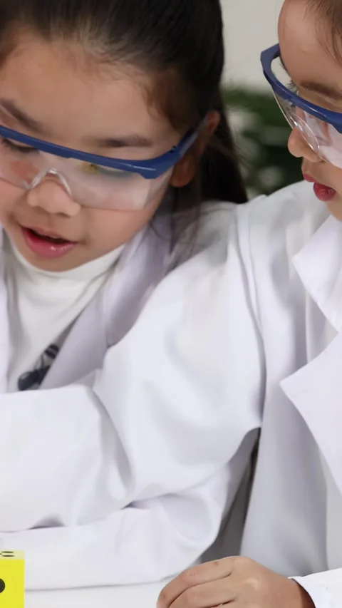 Asian Elementary Students Conducting Magnet Experiment in Science Lab Video stock 338060010