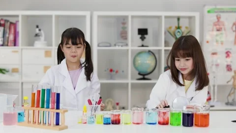 Asian Elementary Students Conducting Science Experiments in School Laboratory Stock Footage 345318799