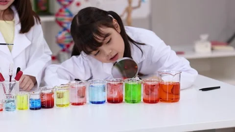Asian Elementary Students in Lab Coats Conducting Science Experiment Stock Footage 341074088