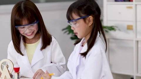 Asian Elementary Students in Lab Coats Giving High Five in Science Classroom Stock Footage 341074128