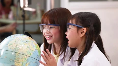 Asian Elementary Students in Lab Coats Studying World Globe Stock Footage 341393036