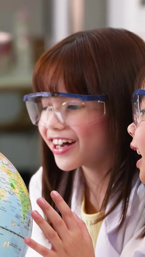 Asian Elementary Students in Lab Coats Studying World Globe Stock Footage 342087342