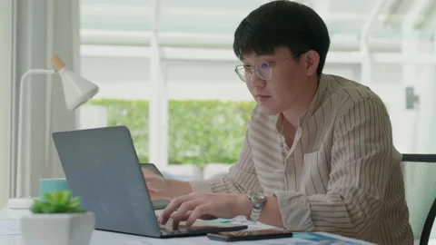 Asian employee man reskill upskill happy work distant remote at home. Stock Footage 162027652