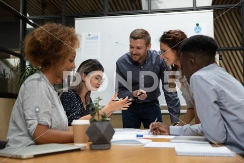 Asian employee telling idea multiethnic project team at office meeting Stock Photos