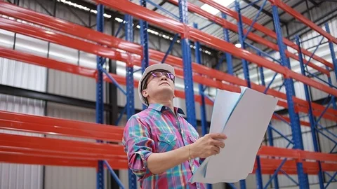 Asian engineer and worker in warehouse 121093046