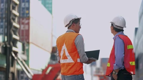 Asian Engineer and workers checking and Shaking hand on site containers area. 스톡 동영상 234263627