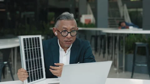 Asian engineer demonstrates solar panel to colleagues online Stock Footage 279972786