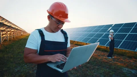 Asian engineer developer with laptop controlling photovoltaic batteries Video stock 139122457