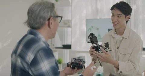 Asian Engineer Discussing Robotic Arm Function With Senior Technician. 스톡 동영상 308232578