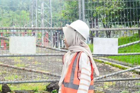 Asian engineer electricity worker checking High voltage tower Stock Photos