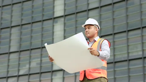 Asian engineer handsome man or architect open the paperwork blueprint and planni Stock Footage 162292238