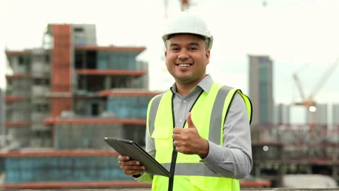 Asian engineer handsome man or architect use tablet with white safety helmet in  Stock Footage 164835198