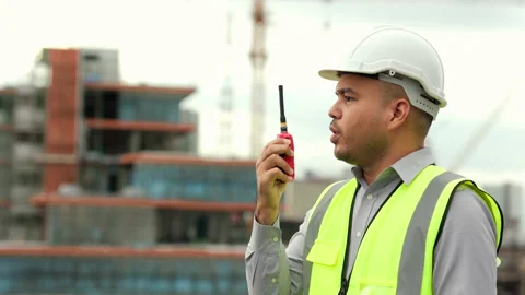 Asian engineer handsome man or architect use radio communication with white safe Stock Footage 164835967
