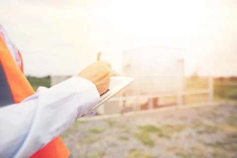 Asian engineer with hardhat using  tablet pc computer inspecting and working 스톡 사진