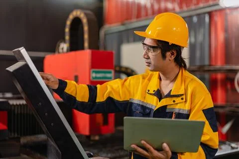 Asian Engineer male worker work control operate machine control panel in me.. Stock Photos