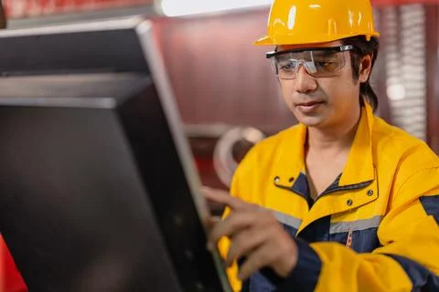 Asian Engineer male worker work control operate machine control panel in me.. Stock Photos